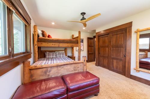 a bedroom with a bunk bed and a couch at Serenity at Dollar Point - Luxurious 4BR w Private Backyard in Tahoe City