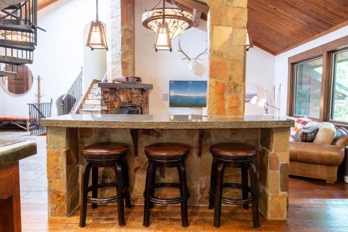 a kitchen with a large island with bar stools at Serenity at Dollar Point - Luxurious 4BR w Private Backyard in Tahoe City