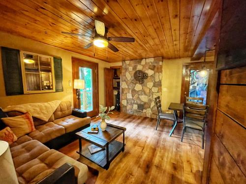 a living room with a couch and a table at 65 Below on Mirror Lake in Highlands