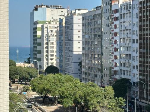 a group of tall buildings in a city at SUÍTE EM COPACABANA - APART HOTEL 200m DA PRAIA, PISCINA, ACADEMIA in Rio de Janeiro