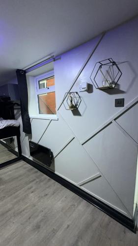 a room with a glass wall with a bed and a window at Studio apartment in bolton town in Bolton