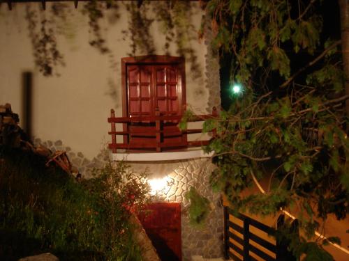 a small window on a building with a fence at Rem's Pension in Râşnov