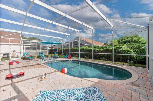 a swimming pool with a canopy over it at Chatham House in Kissimmee