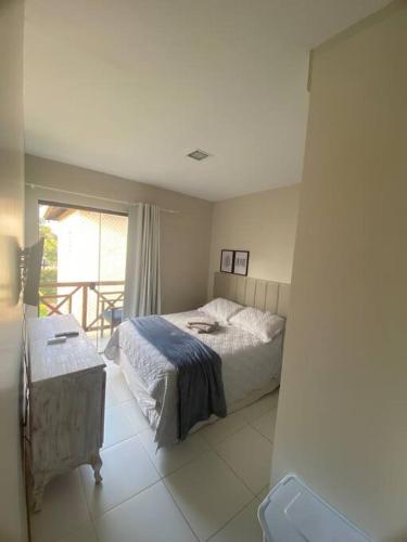a bedroom with a bed and a balcony at Praia da Espera - Paraíso em Itacimirim - Quinta das Lagoas Reserva in Monte Gordo