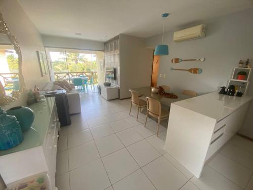 a kitchen and living room with a table and chairs at Praia da Espera - Paraíso em Itacimirim - Quinta das Lagoas Reserva in Monte Gordo