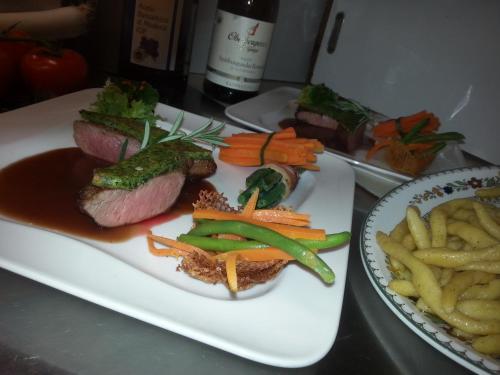 a plate of food with meat and vegetables and french fries at Hotel Kleins Wiese in Schmallenberg