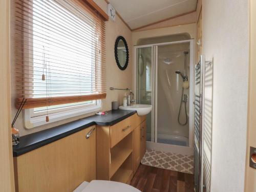 a bathroom with a toilet and a sink and a shower at Ashcroft in Preston