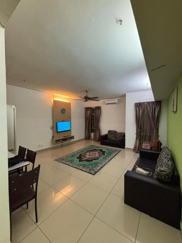 a living room with a couch and a tv at Homestay Aspirasi Viana in Kota Bharu