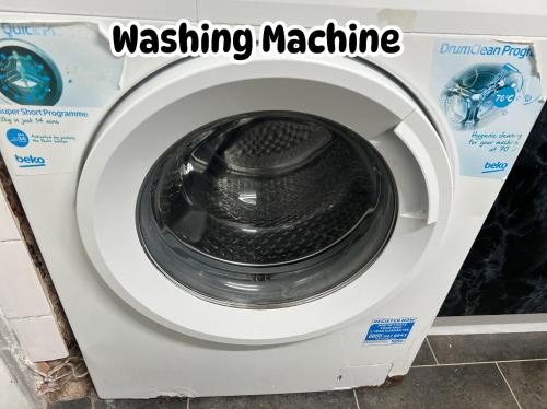 a washing machine with the words washing machine at Manchester City Cosy Stay - Fresh New Master bedroom Sleeps 3 Guests - 3 Adults in Manchester