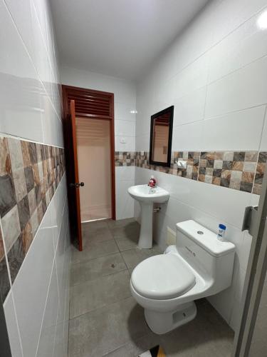 a bathroom with a toilet and a sink at Siéntete como en casa SP in Iquitos