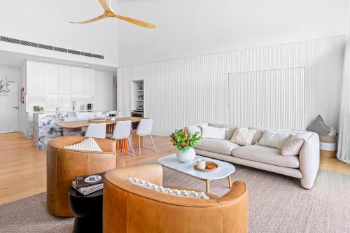 a living room with a couch and a table at Luxurious Ocean View Penthouse in Sunshine Beach