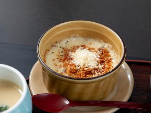 a cup of coffee on a plate with a spoon at Sasara in Gero