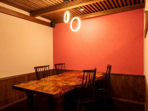 a dining room with a wooden table and chairs at Sasara in Gero