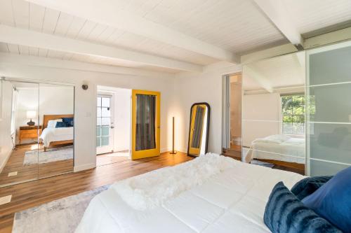 a bedroom with a large white bed and a mirror at The Berkeley Haven in Berkeley
