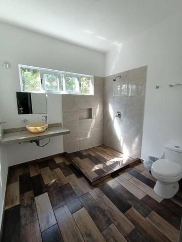 a bathroom with a toilet and a sink and a shower at Casa Balam en Puerto Morelos in Puerto Morelos