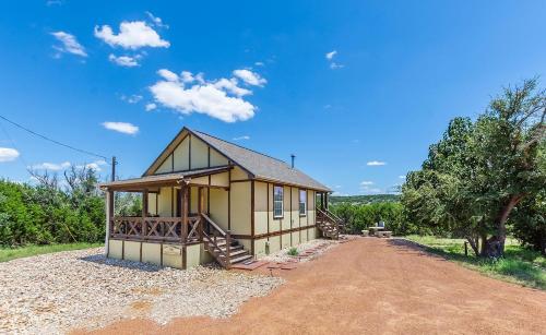 a small house on a dirt road at Appian Way Oliva Cottage in Fredericksburg