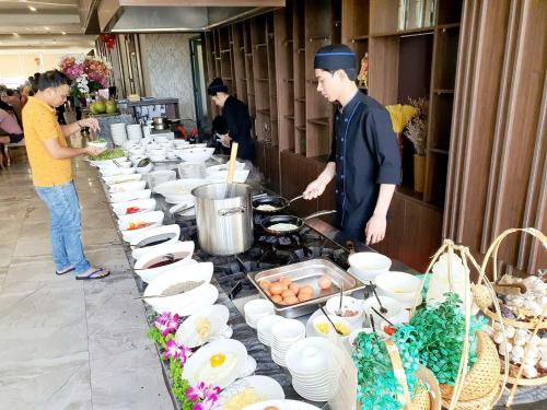 a group of people in a kitchen preparing food at Vesna Hotel Nha Trang in Nha Trang