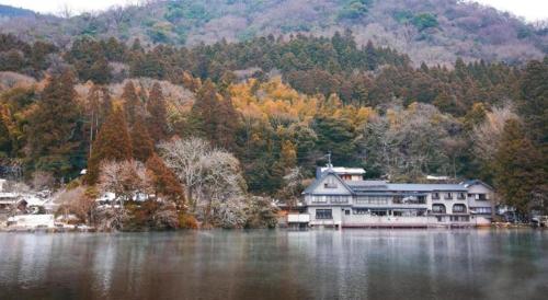 a large house on the shore of a lake at Secret Base Tokinokakera in Yufuin