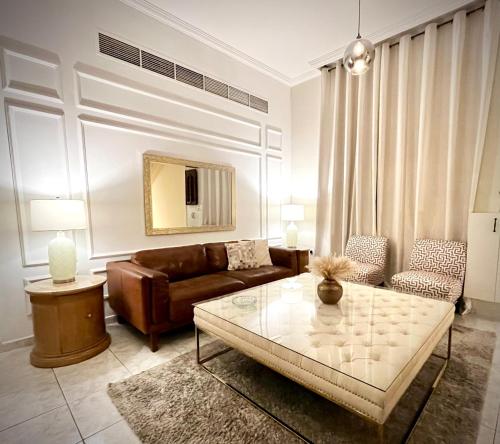 a living room with a couch and a coffee table at Brightful and joyful 4 bedroom villa in Dubai