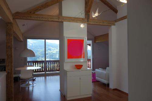 a living room with a table and a dining room at Villa Bergfrieden in Oberstaufen