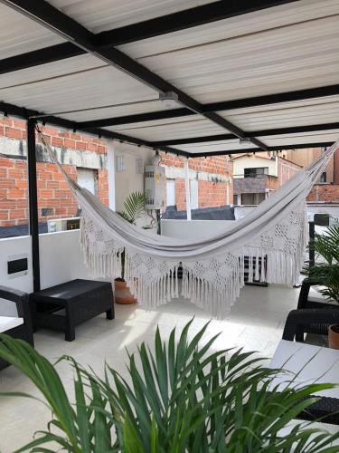 a hammock on a patio in a building at Apto 203 - Casa bendita in Medellín
