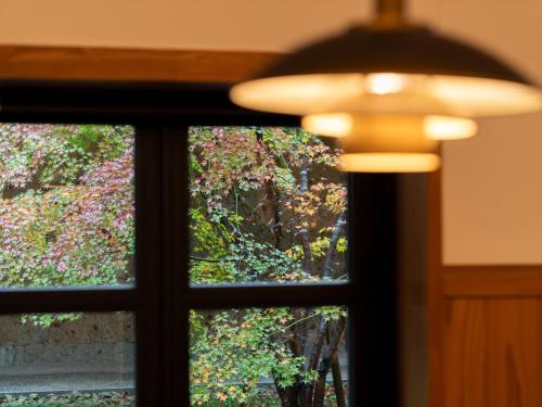 a window with a view of a tree at Nikko Nishimachi Club in Nikko