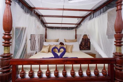 a bedroom with a bed with a purple ribbon at Morning Star Polhena in Matara