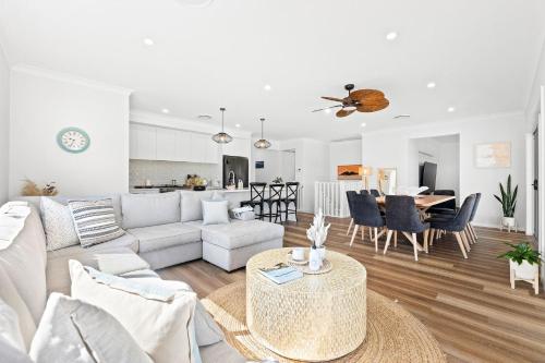 a living room with a couch and a table at 9 Woods Place, North Narooma in Kianga