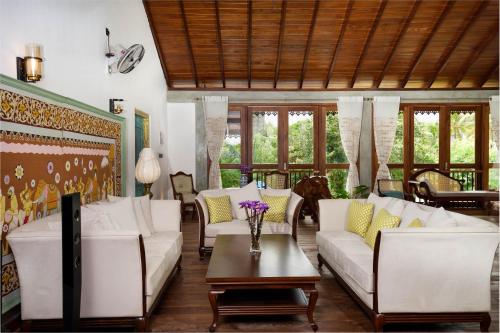 a living room with white couches and a table at Morning Star Polhena in Matara