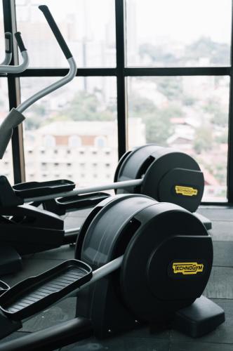 a row of treadmills in a gym with a window at Urban Suites Infinity Pool 3BR 2Carparks 8pax in Jelutong