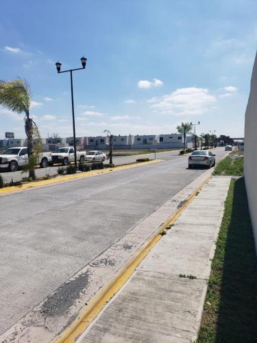 an empty street with cars parked in a parking lot at 3 bedroom with pool in Reynosa