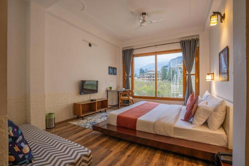 a bedroom with a bed and a large window at Alt Life Manali, Old Manali in Manāli