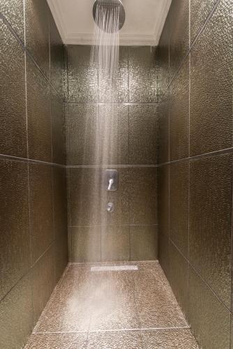 a bathroom with a shower with a shower head at Akar International Hotel in Ankara