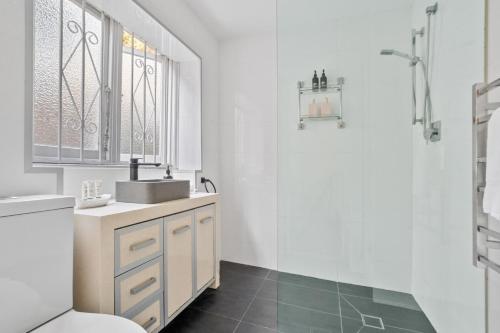 a bathroom with a sink and a toilet at Pet-Friendly Home Just Minutes from Bondi Beach in Sydney