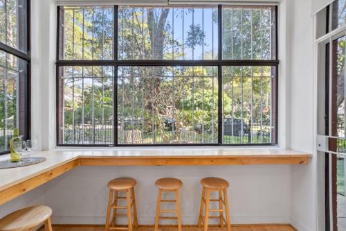 a bar with stools in front of a window at Pet-Friendly Home Just Minutes from Bondi Beach in Sydney