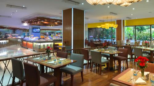 a restaurant with tables and chairs and a bar at The Suite- Luxurious City Skyline in Cebu City