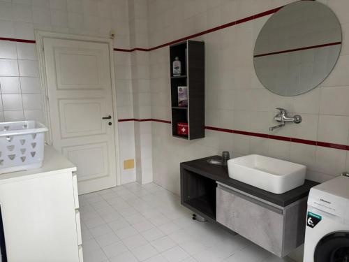 a small bathroom with a sink and a mirror at Splendid Villa Magna with Pool and Park - Langhe Hills in Govone