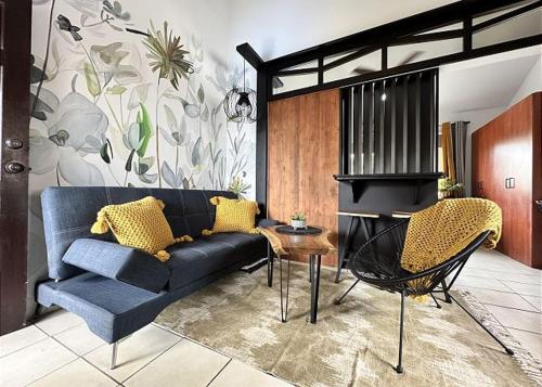a living room with a blue couch and a fireplace at Designer-inspired 1bed1bath Condo Close To Beach in Coco