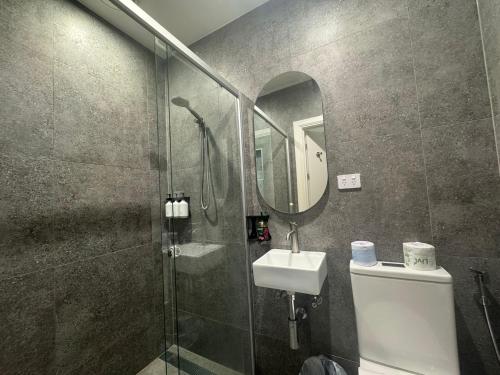 a bathroom with a shower and a toilet and a sink at K2 Brisbane in Brisbane