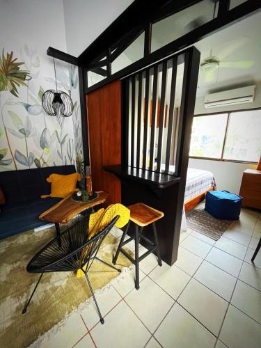 a living room with a table and a chair at Designer-inspired 1bed1bath Condo Close To Beach in Coco