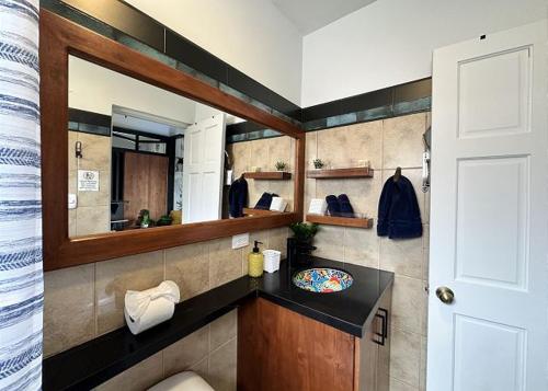 a bathroom with a sink and a mirror at Designer-inspired 1bed1bath Condo Close To Beach in Coco