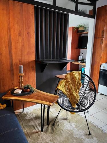 a living room with a table and a chair at Designer-inspired 1bed1bath Condo Close To Beach in Coco