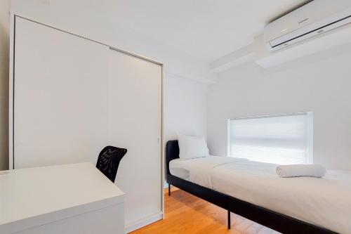 a bedroom with two beds and a mirror at Spacious and Elegant 3BR Loft at Kingland Avenue Apartment By Travelio in Tangerang