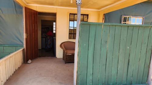 an entrance to a house with a green gate at Amanya 2 Bedroom Self Catering Tent in Amboseli