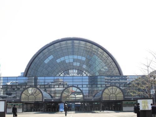 a large glass building with people walking in front of it at Hotel -ASIATO- in Osaka