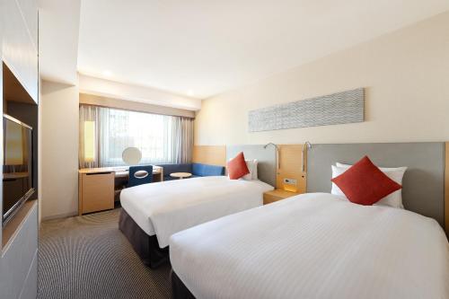 Postel nebo postele na pokoji v ubytování Hotel JAL City Kannai Yokohama