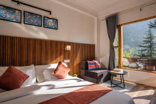 a hotel room with a bed and a large window at Alt Life Manali, Old Manali in Manāli