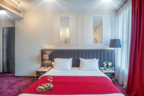 a bedroom with a large bed with a red blanket at King Gorgasali in Tbilisi City