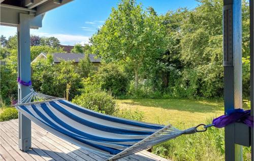 a hammock on the porch of a house at 4 Bedroom Cozy Home In Torekov in Torekov