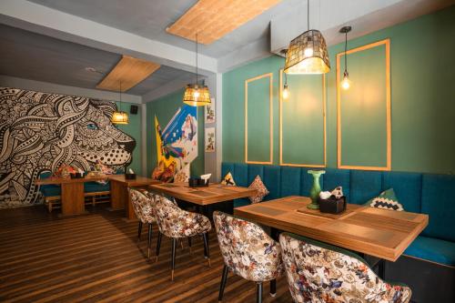 a dining room with wooden tables and chairs at Alt Life Manali, Old Manali in Manāli